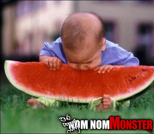 Baby eating huge piece of watermelon